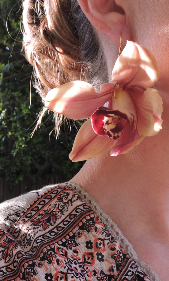women wearing pink orchid earring 