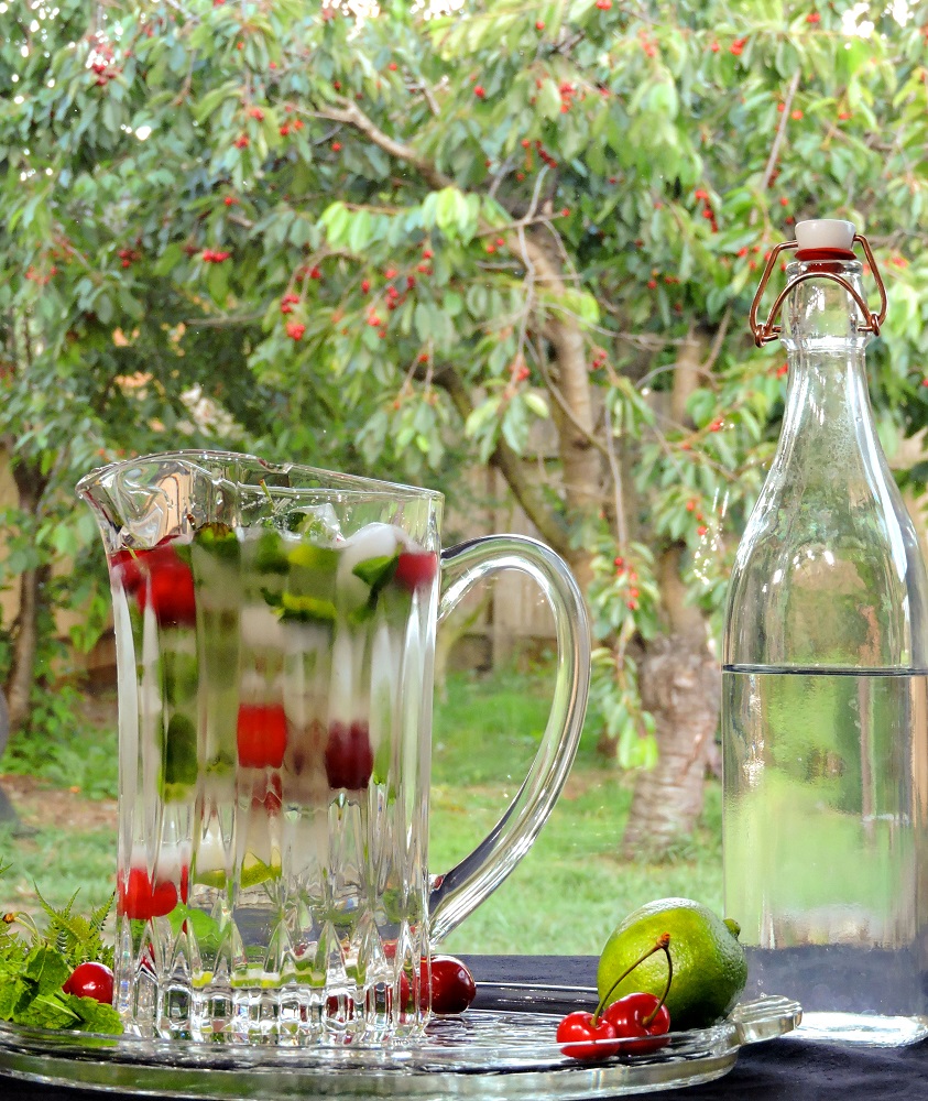 glass pitcher filled with cherry mint lime sparkling water
