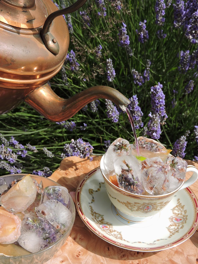 lavender rose petal ice tea pouring from bronze tea pot into tea cup
