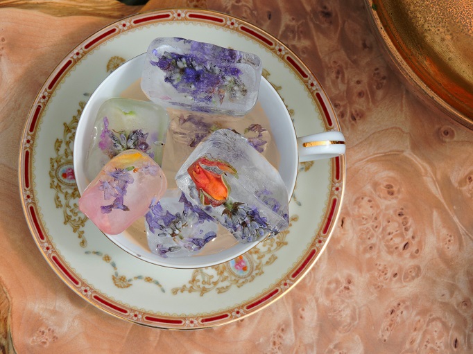 rose petal iced tea in a tea cup with flower ice cubes
