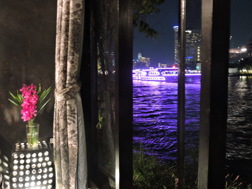 view from room at night with river and boats