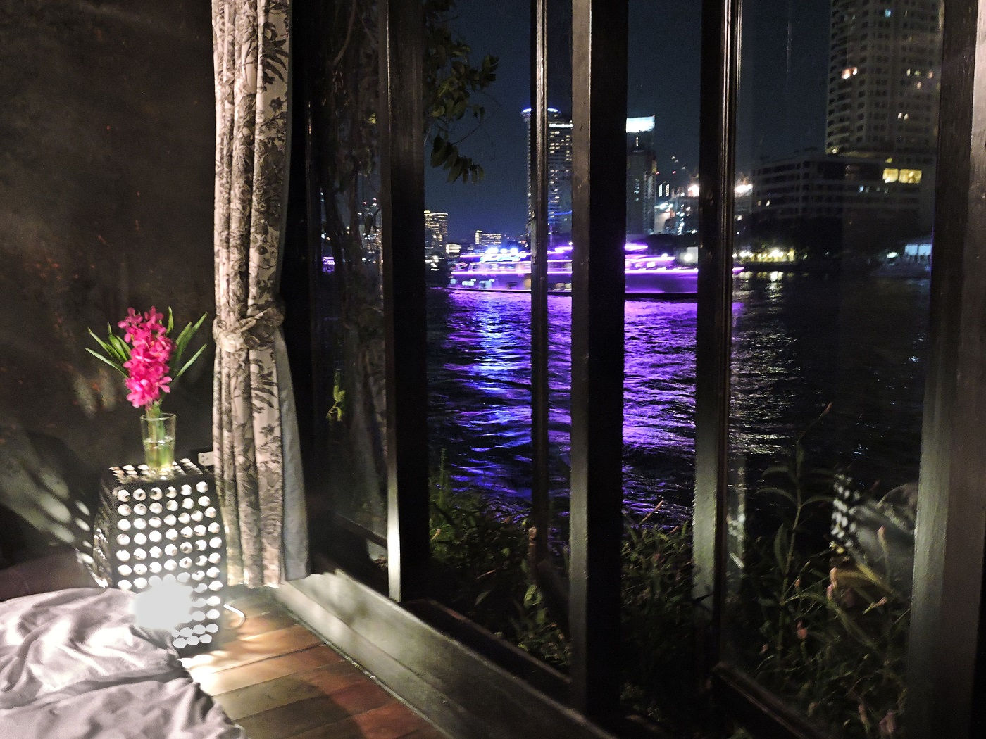 night time view from hotel room of river with lights