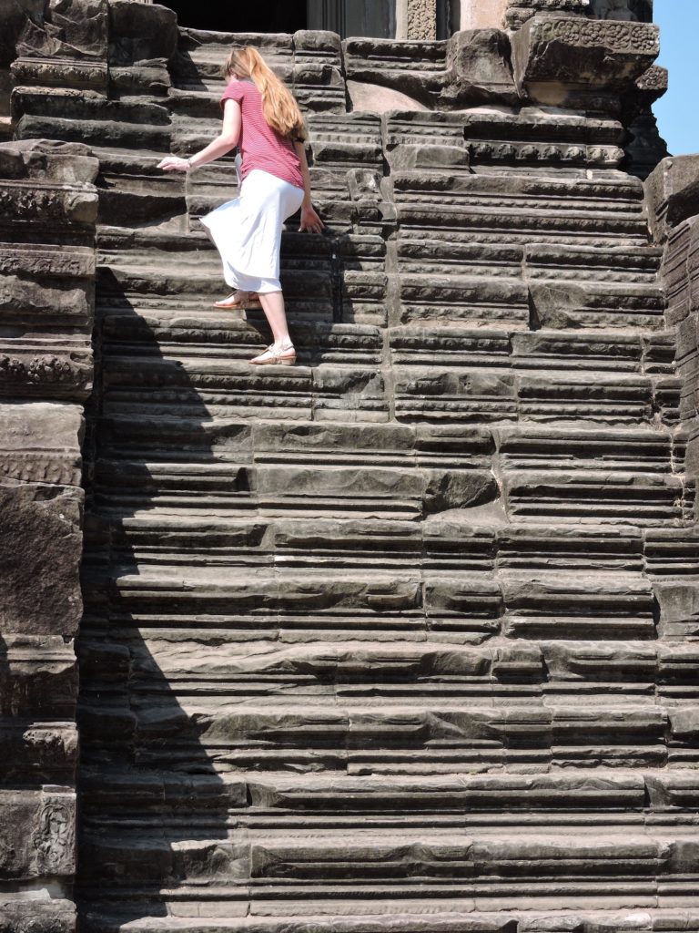 climbing steps to library at Angkor Wat