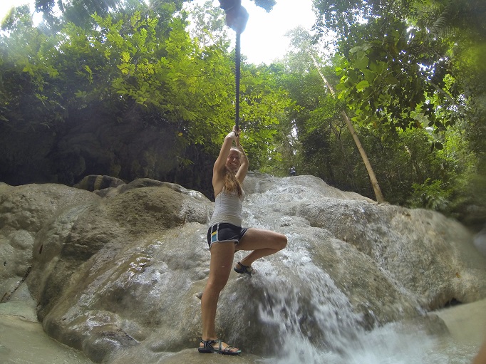 using a rope to climb up middle level of Aguinid falls