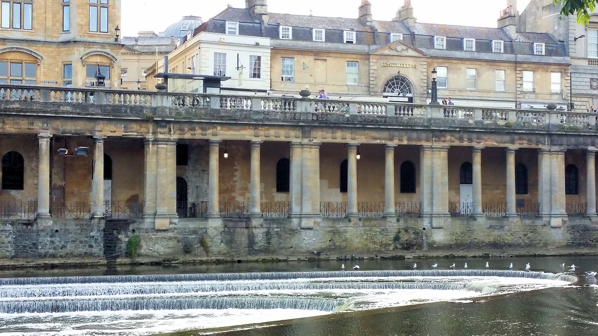 golden limestone buildings along river