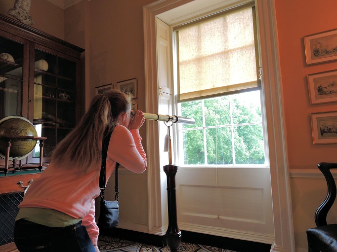 museum room with looking glass and globe