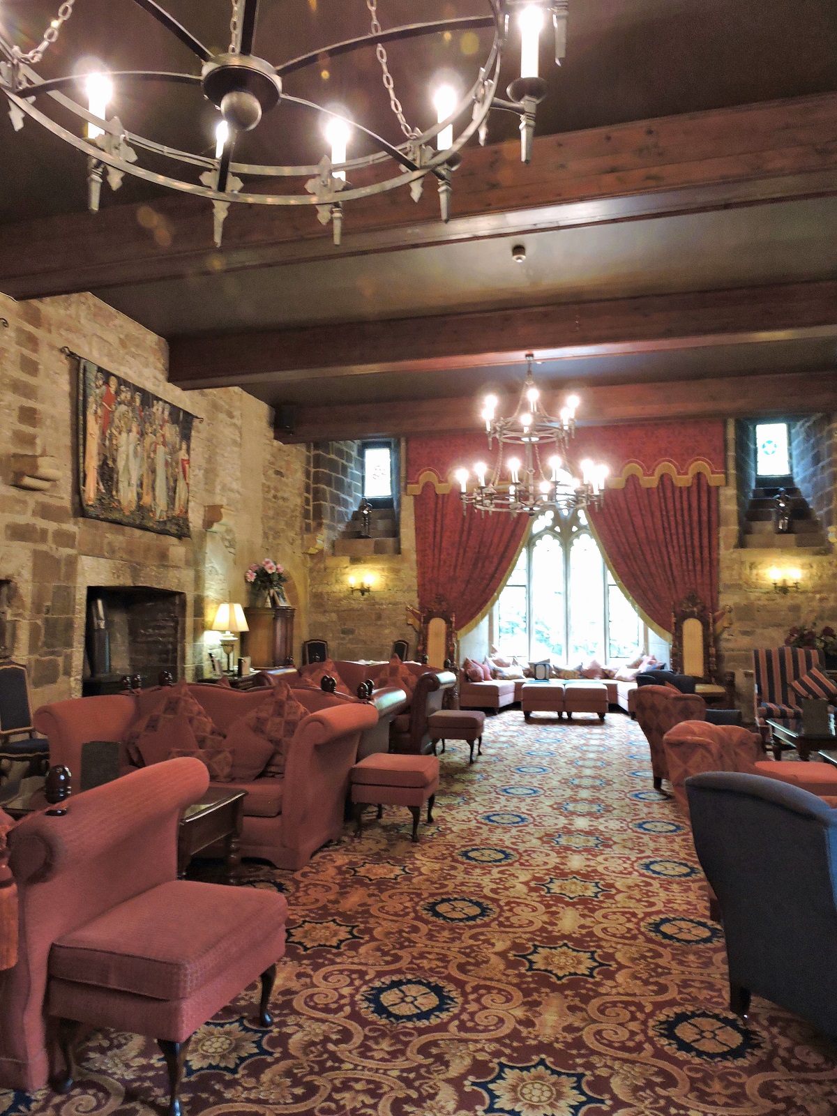 Great room with red motif chandeliers and tapestries