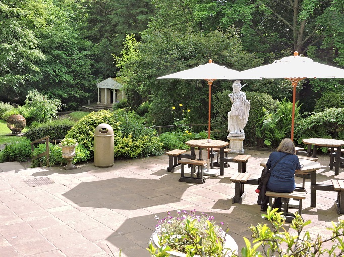 outdoor cafe surrounded by gardens