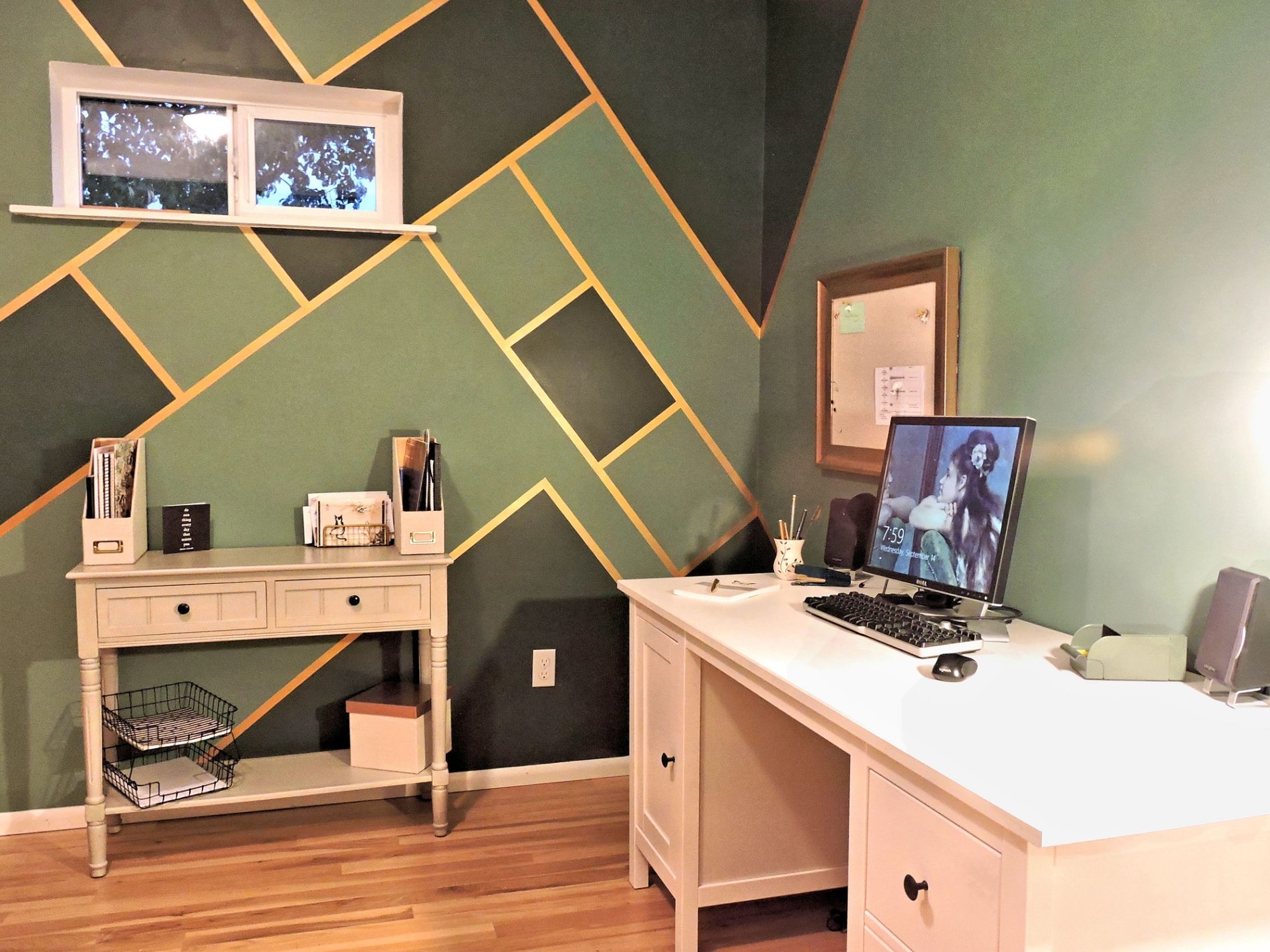 room painted dark green with gold lines and stripes