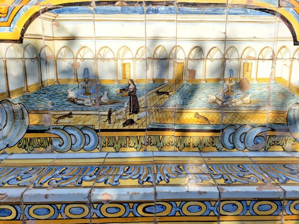 close up of painted tiles with cats being fed