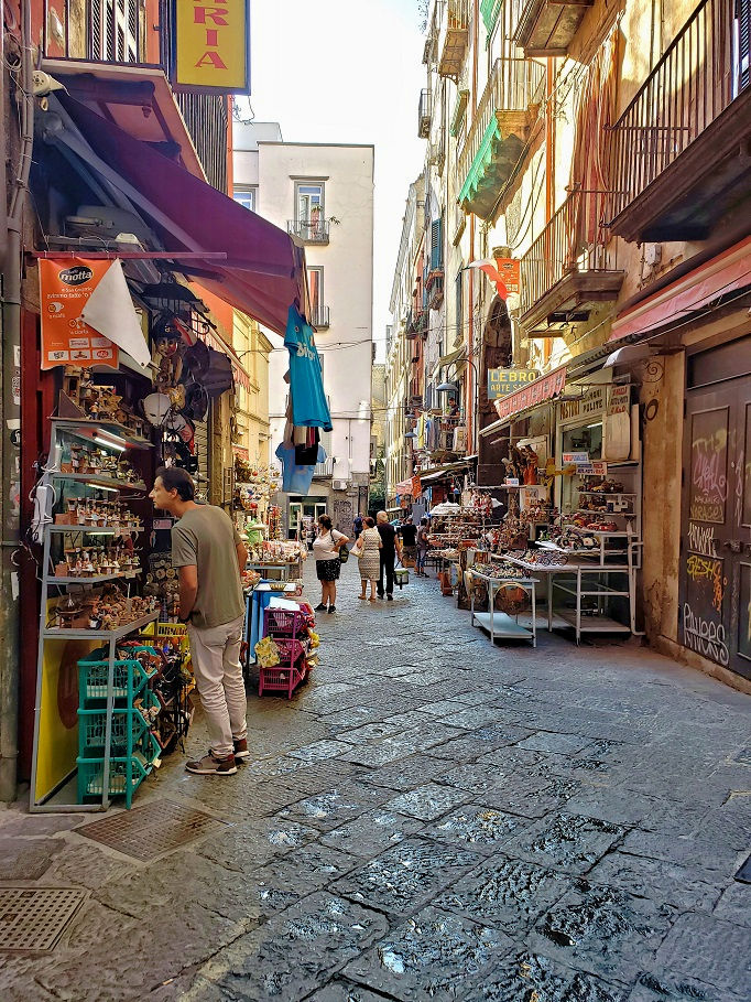 cluttered narrow street with shops