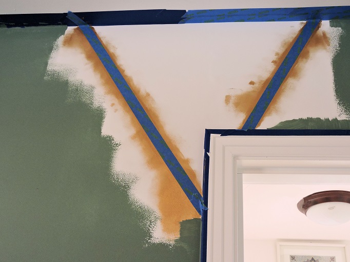 scotch blue tape over gold paint and green paint in progress