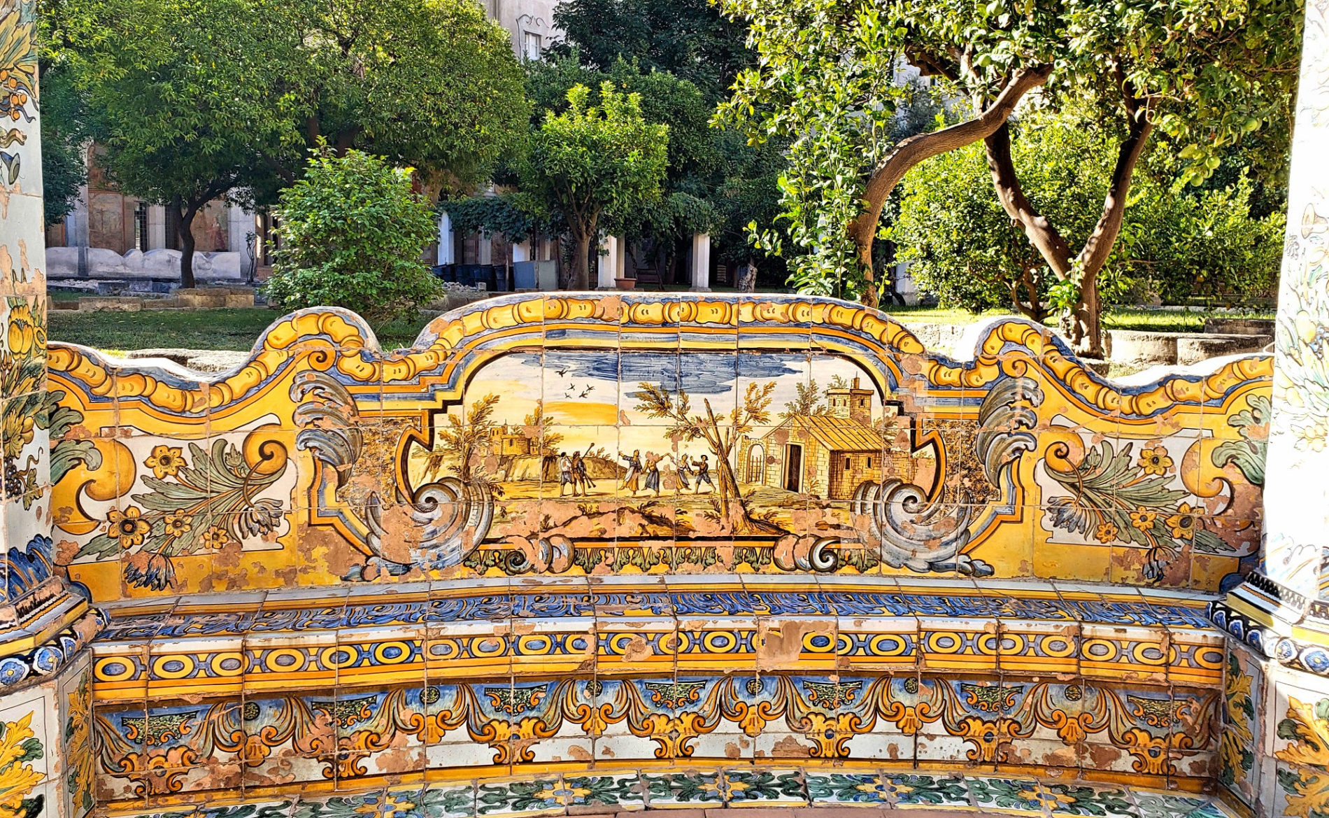 splendid beautiful yellow blue tiled bench in cloister garden of Santa Chiara
