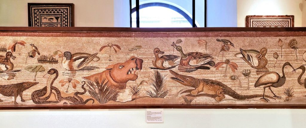 mosaic with animals in the water and on the water bank