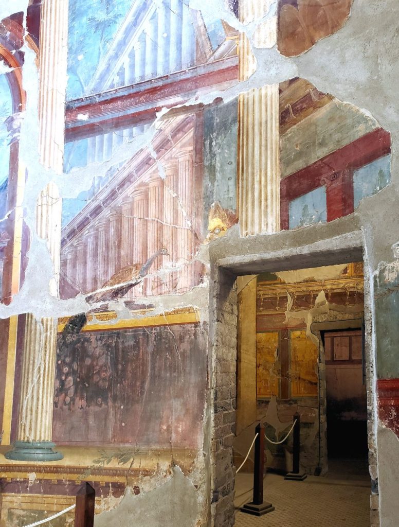 painted walls from a villa with doorways leading to rooms with more painted frescos