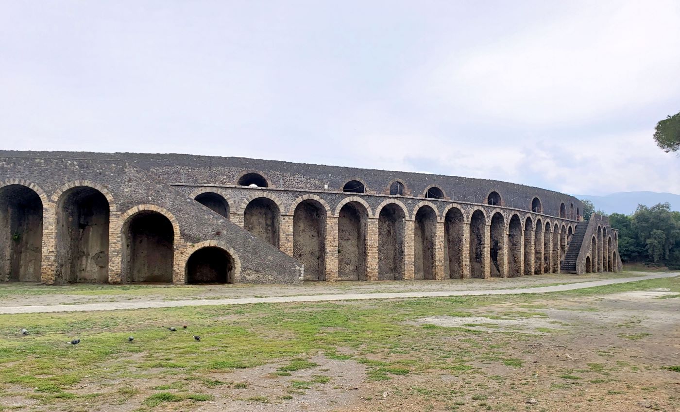 wide angle view of Pompeii's amphitheater showing the unique external staircases