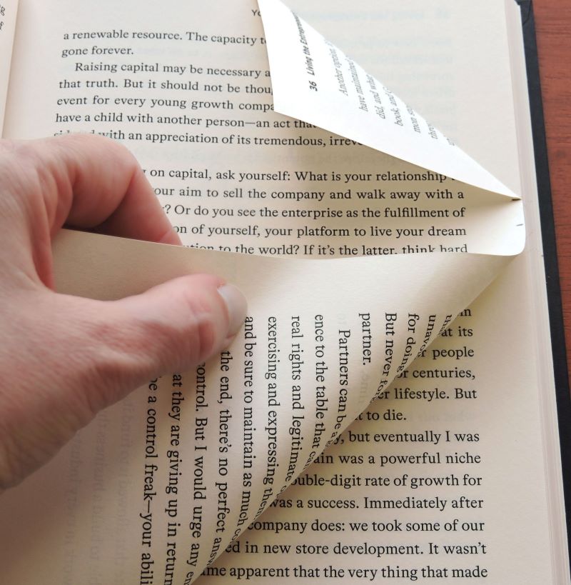 folding bottom corner of book's page up