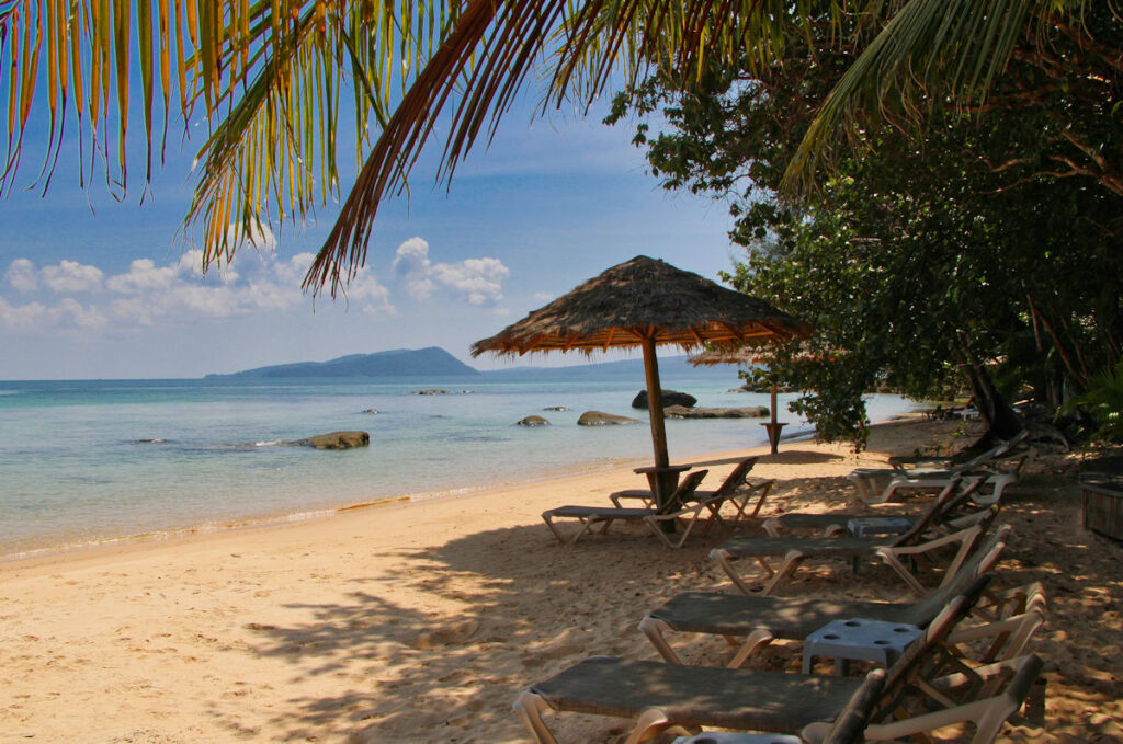 sandy beach with loungers and umbrella