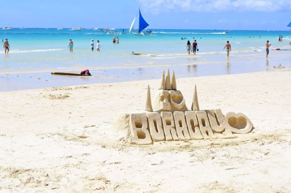 sand sign on beach with people