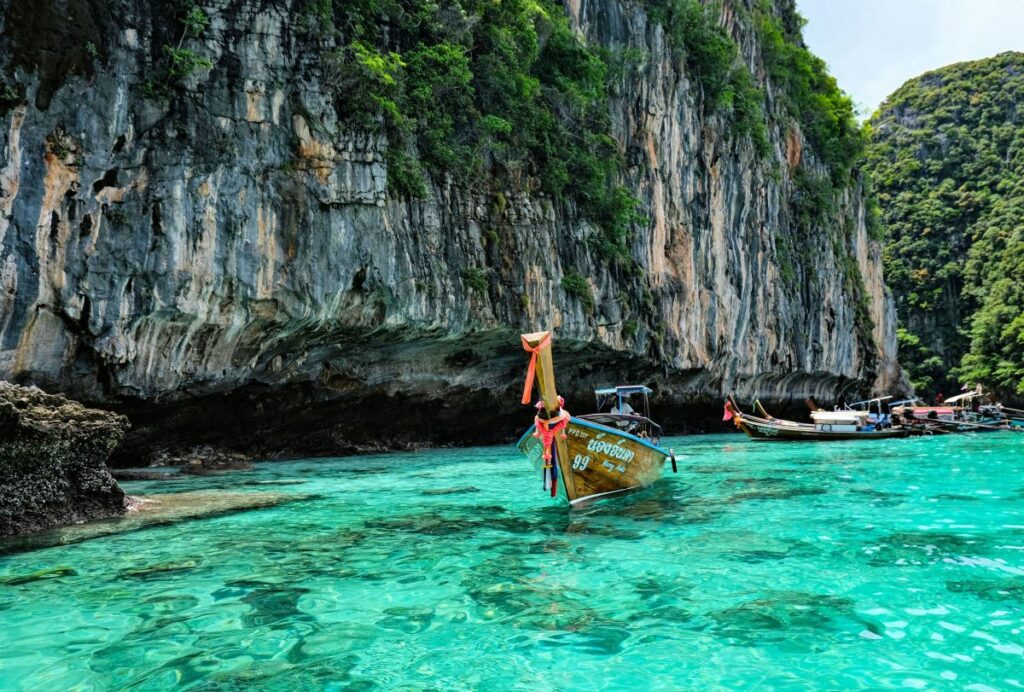 long tail boats on clear turquoise water
