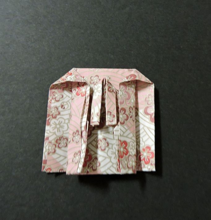 pink and gold paper folded step six of kimono pattern