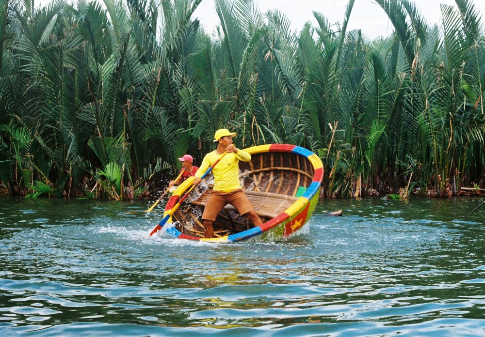 man paddles basket boat