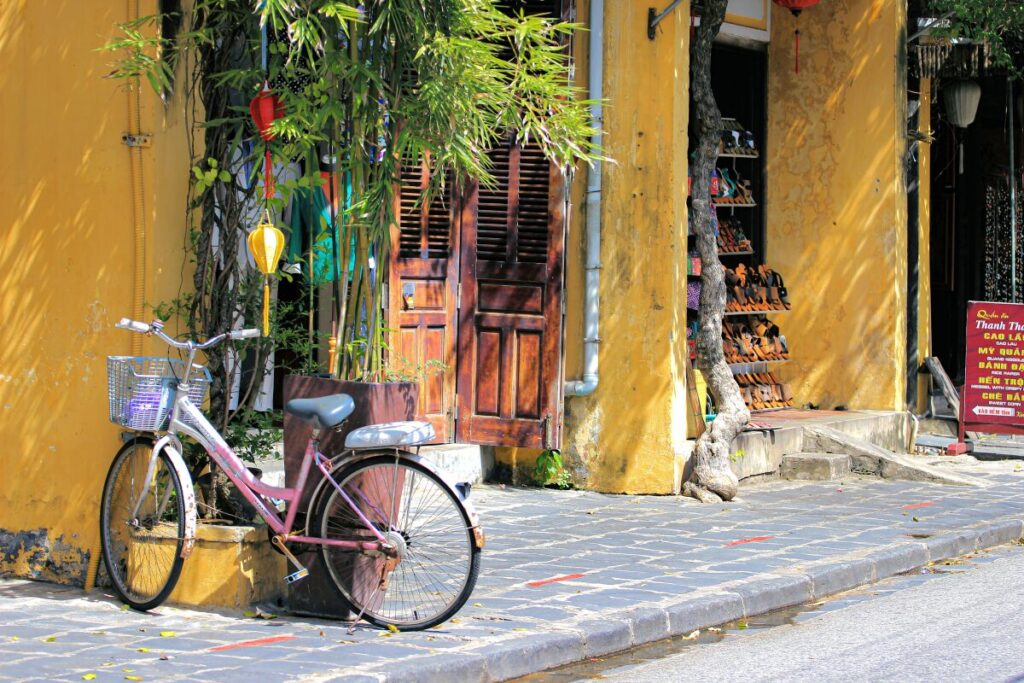 bicycle leaning against yellow walls