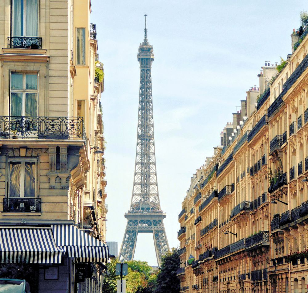 Eiffel tower between Paris buildings