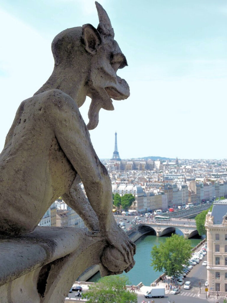 stone gargoyle with Paris and Eiffel tower in background