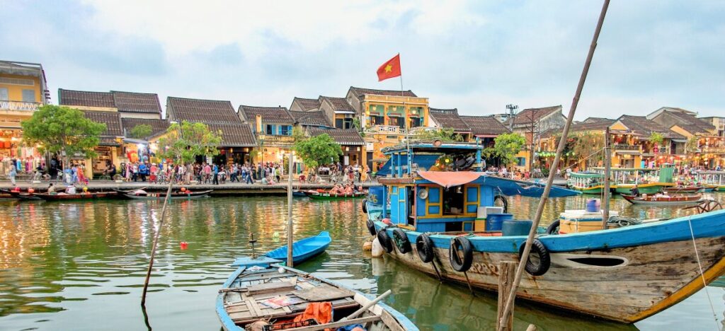 boats on the river with yellow houses