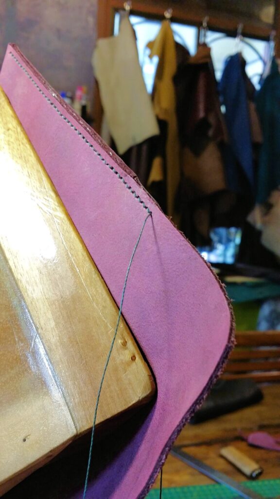 purple leather and blue thread sewing