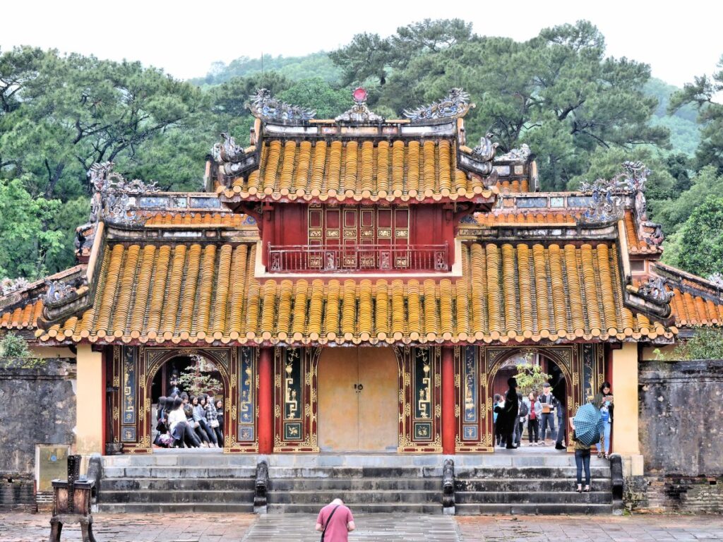 yellow tiled roof red pillars mausoleum