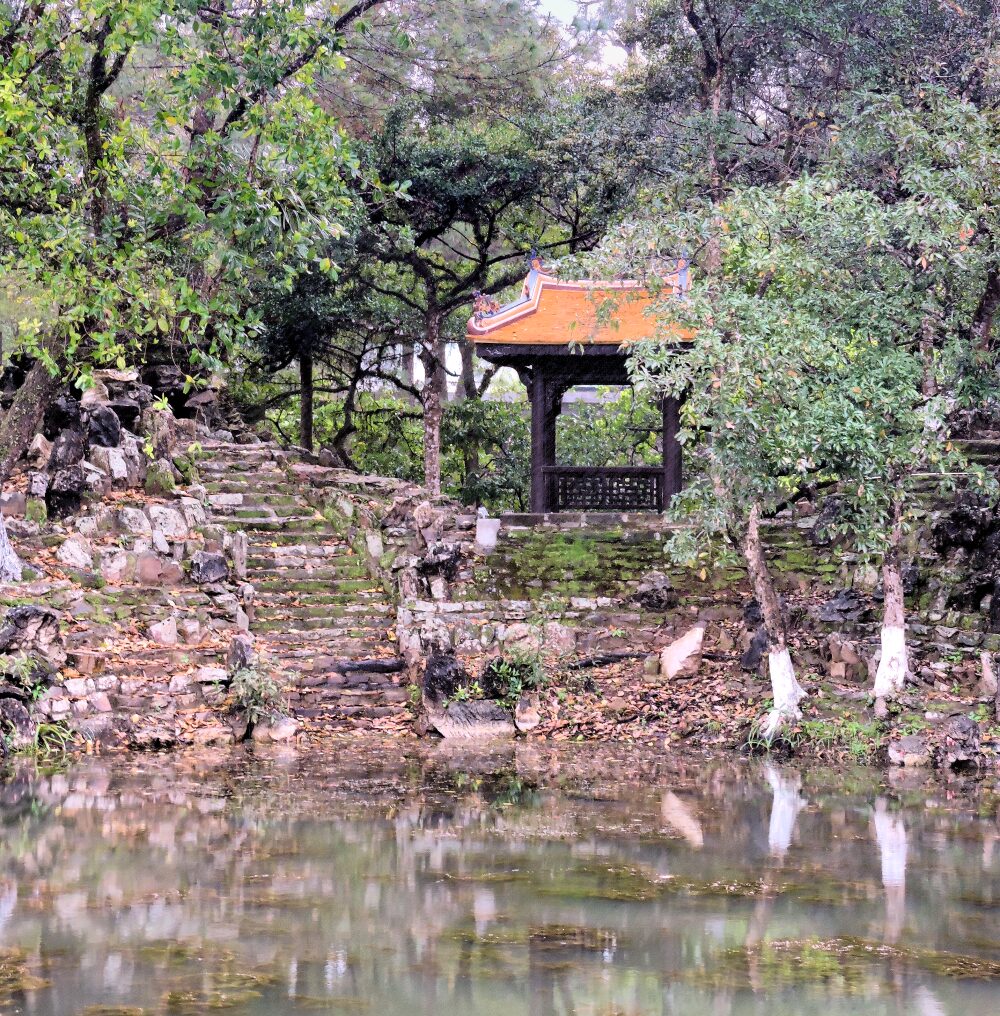 pavilion and rock stairs to pond in garden