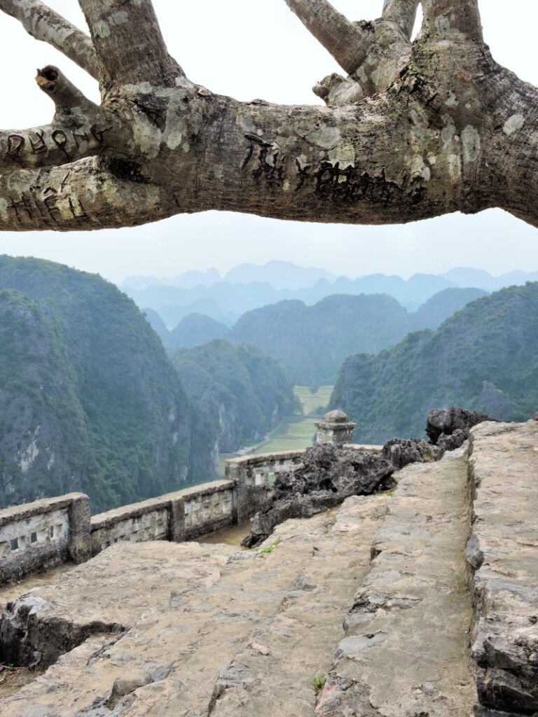 steps past viewpoint on mountain of countryside below